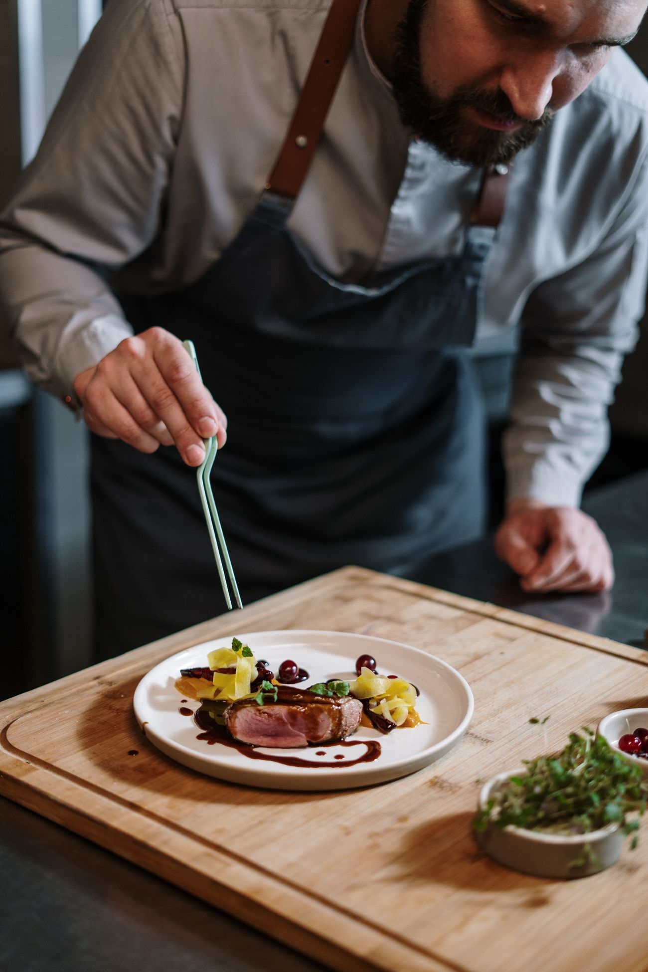 Chef carefully plating a seasonal fine-dining dish