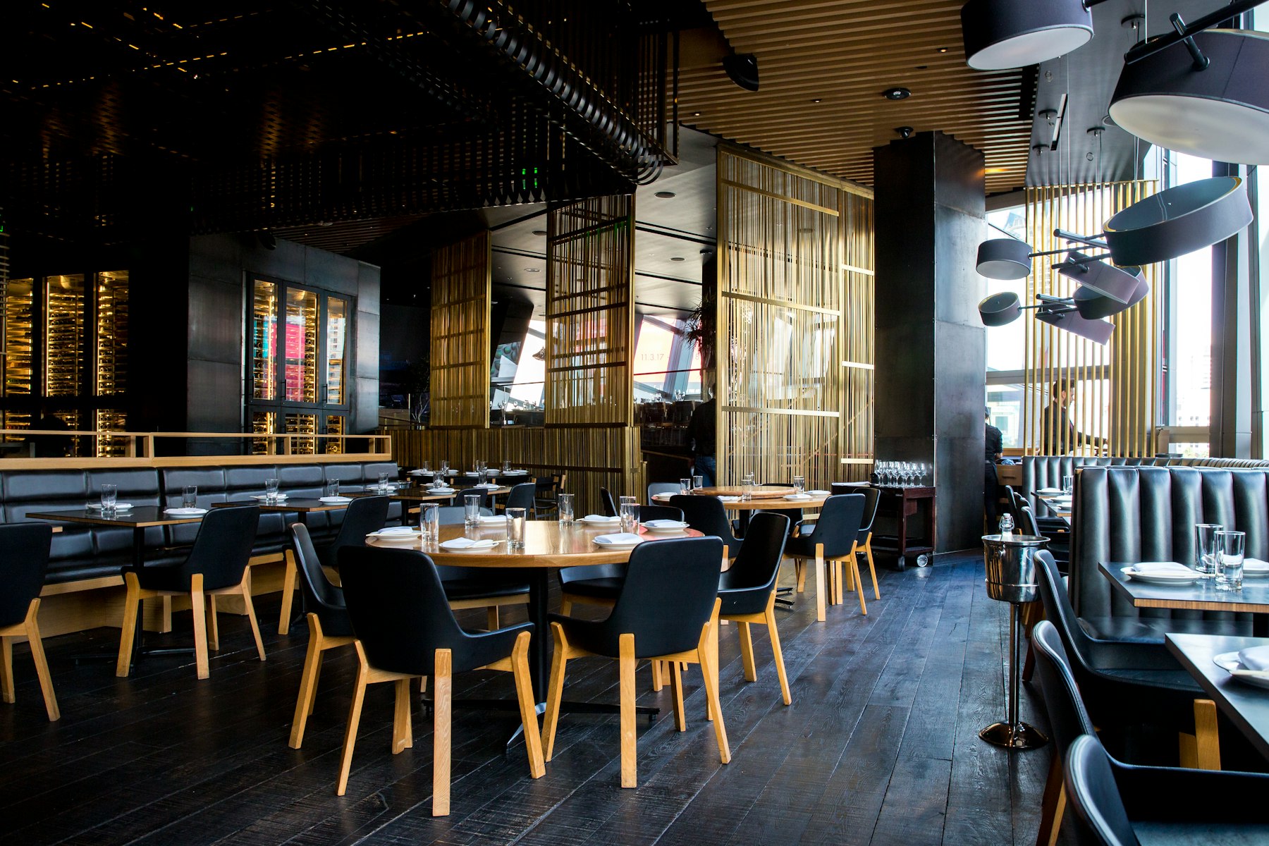 Warm modern restaurant dining room prepared for an evening service