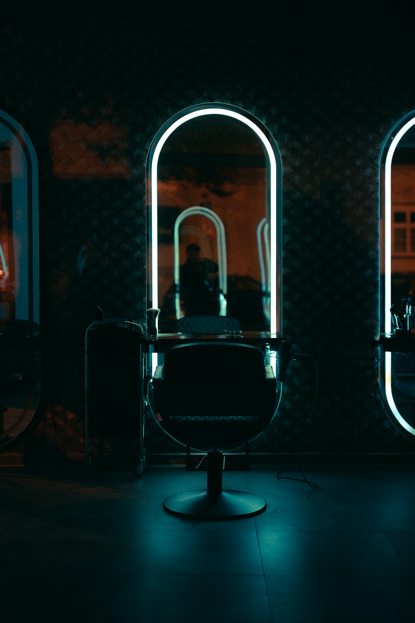 Warm modern barbershop interior with barber chairs and mirror stations
